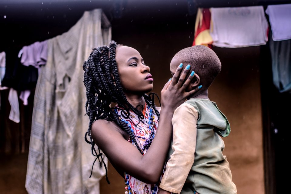 Girl With Braided Hair Standing While Carrying Boy Wearing Beige Long-sleeved Top