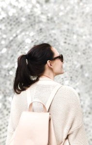 Woman Wearing White Sweatshirt And Backpack photo