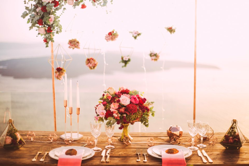 Pink And Red Roses Centerpiece Near Silverwares