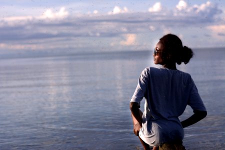 Woman Sitting By The Ocean photo