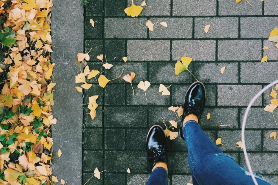 Person Wearing Black Patent Leather Dress Shoes On Gray Brick Pathway