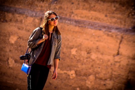 Woman Wearing Brown Jacket With Blue Leather Crossbody Bag