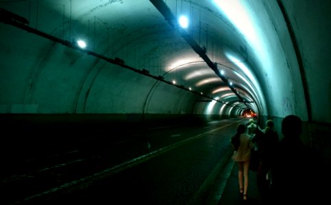 Group Of Persons Passing By Tunnel