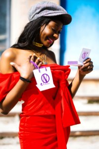 Woman In Red Tube Dress Holding Paper Bag photo