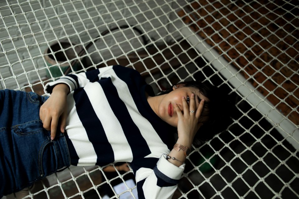 Woman In Black And White Striped Long-sleeved Top Lying On Black Net