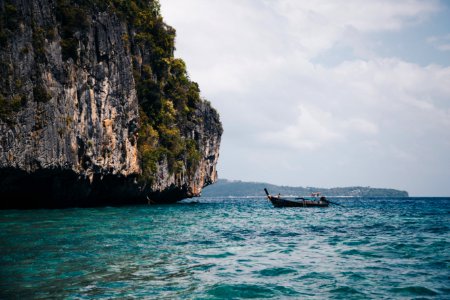 Boat Beside Cave On Body Of Water photo