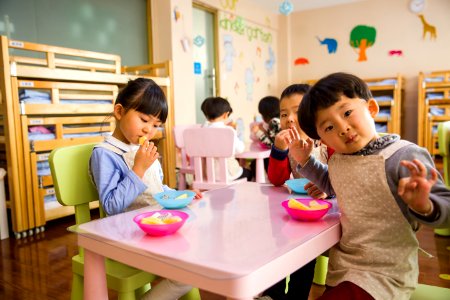 Three Toddler Eating On White Table