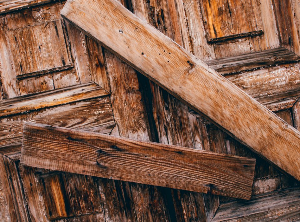 Selective Photo Of Two Brown Wood Lumbers Barring A Door