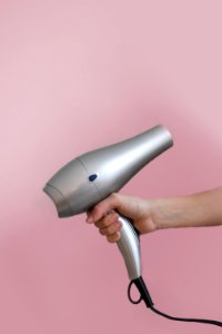 Person Holding Grey Hair Dryer photo