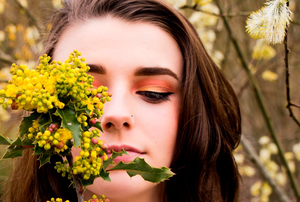 Woman Looking At A Green And Yellow Leafed Plant