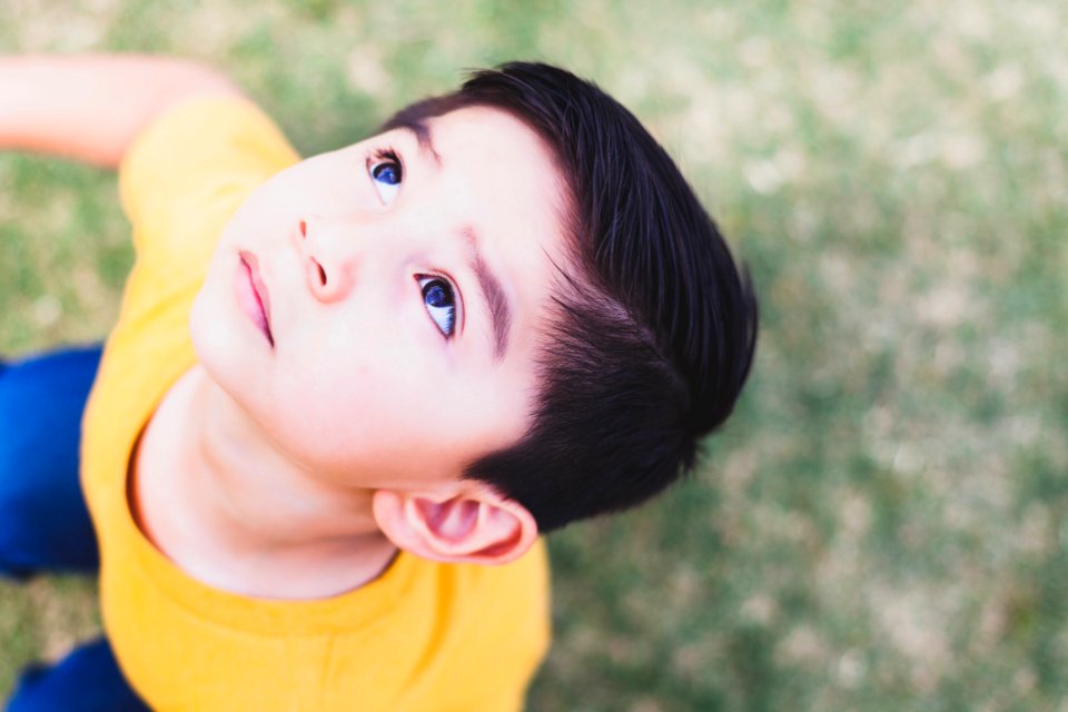 Boy Wearing Yellow Crew-neck T-shirt And Blue Bottoms Outfit Looking Above