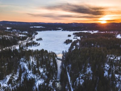 Aerial Photo Of Snowy Forest During Sunset photo