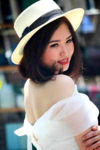 Woman In Brown Fedora Hat And White Off-shoulder Dress photo