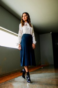 Woman Wearing White Long-sleeved Shirt And Blue Skirt photo