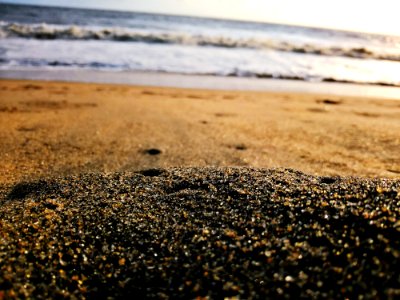 Low-angle Photography Of Sand Near Body Of Water photo