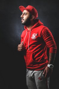 Man Wearing Red Pullover Hoodie And Gray Pants photo