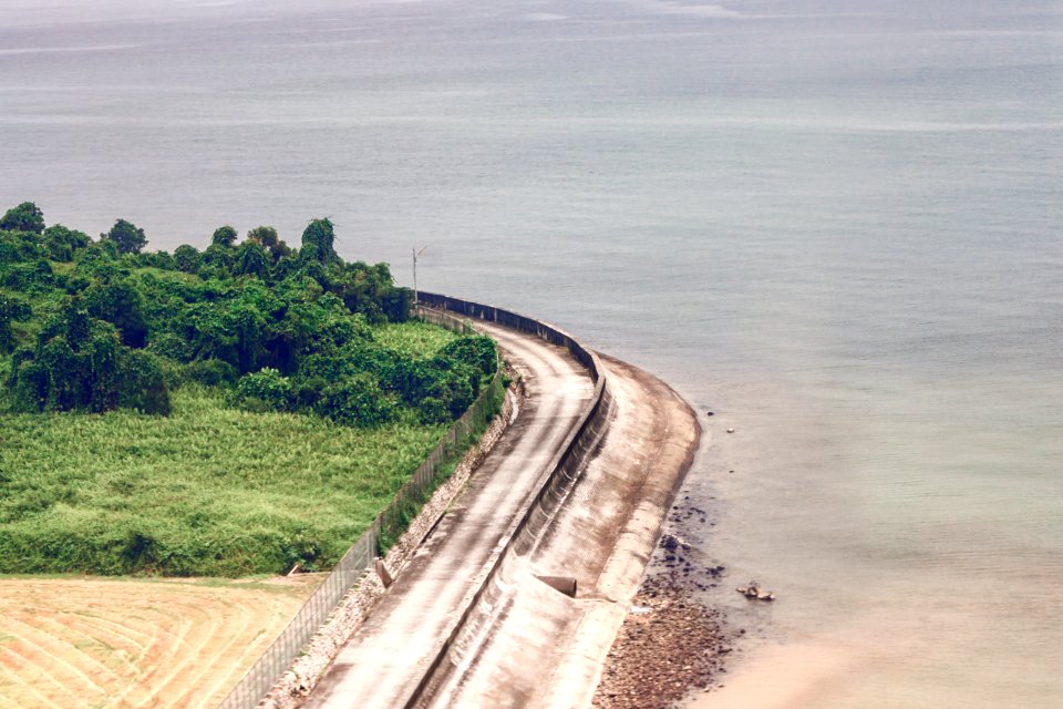 Brown Concrete Road Near Body Of Water