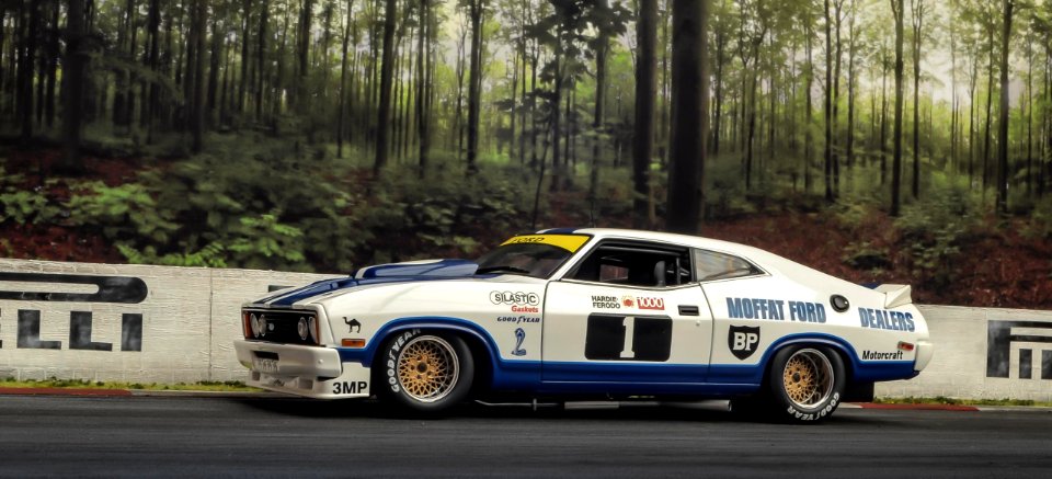 White And Blue Coupe On Road