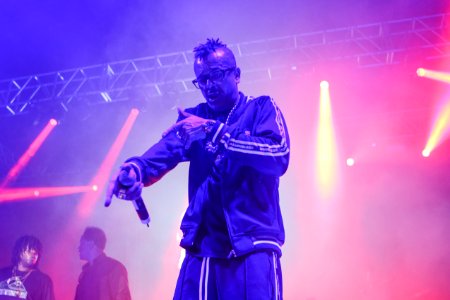 Man Wearing Zip Jacket Having Concert On Stage photo