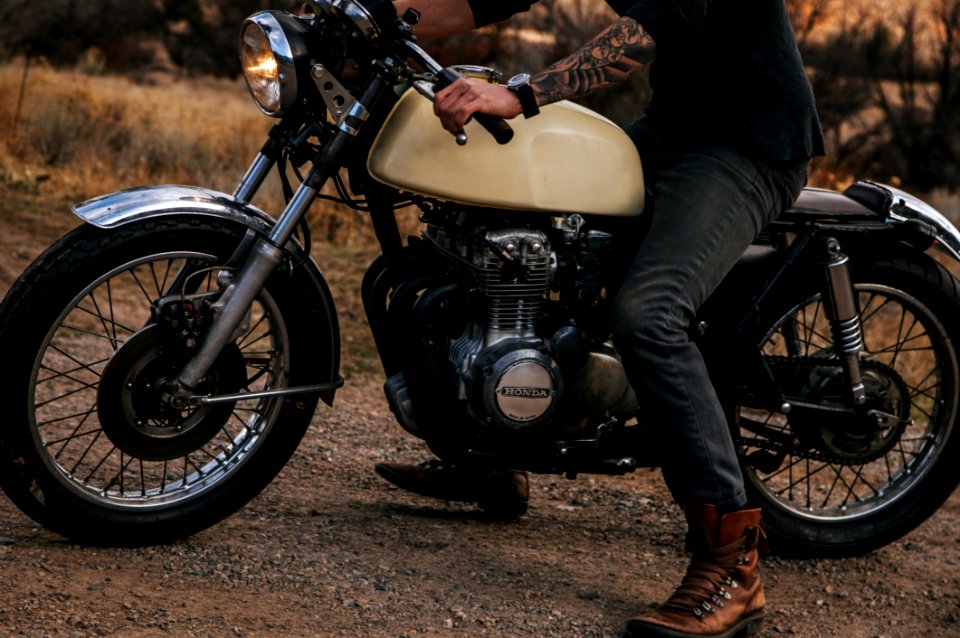 Man Riding Beige Naked Motorcycle