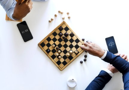 Flat Lay Photography Of Two Men Playing Chess photo