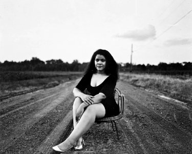 Grayscale Photography Of Woman Sitting On Chair photo