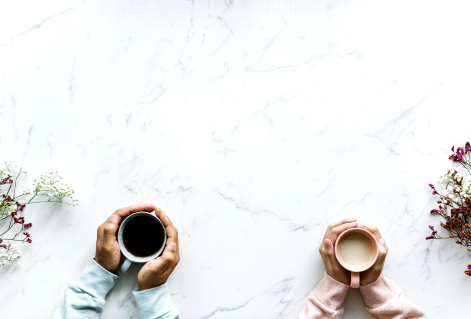 Person Holding Mug On Table