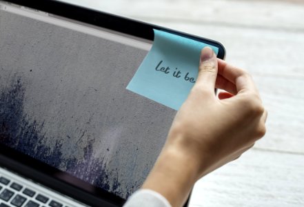 Person Holding Blue Sticky Note