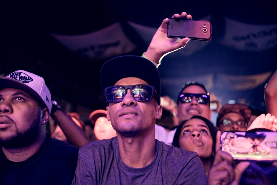 Man Wearing Black Sunglasses Sitting Next To Man