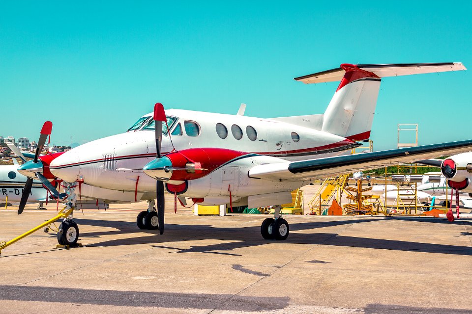 White And Red Plane Land