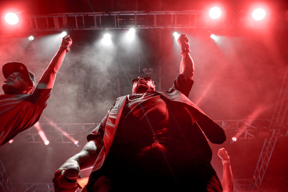 Two Men Standing Raising Right Hands