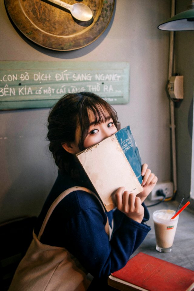 Woman Sitting On Chair Holding Abook photo