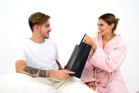 Man And Woman Holding Black Tote Bag photo