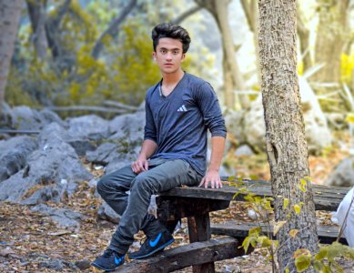 Man Sitting On Wooden Table photo