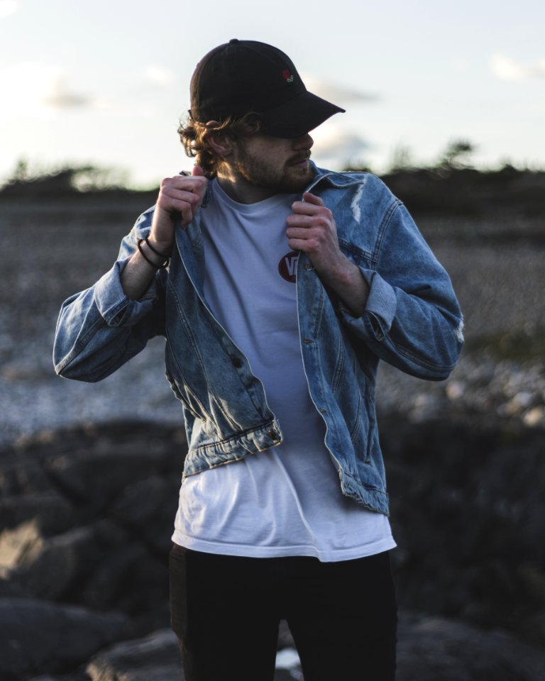 Man In Blue Denim Jacket White Crew-neck Shirt And Black Pants photo