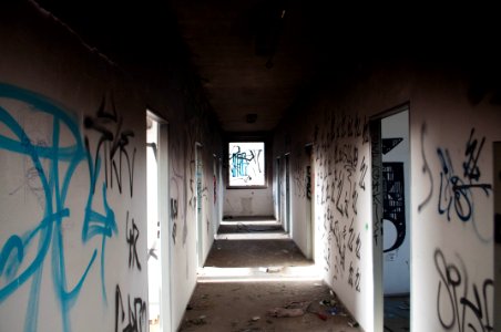 Empty Hallway With Black And Blue Graffiti