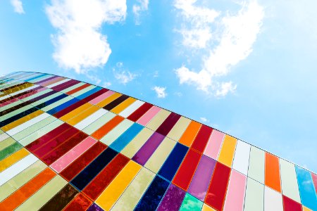 Low Angle Of Colorful Glass Panels Under Blue Sky photo