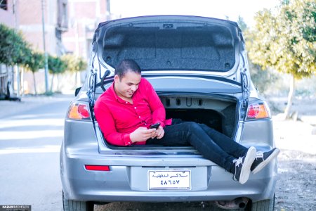 Man Seating On Car Trunk