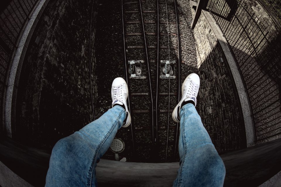 Person In Blue Denim Stonewashed Fitted Jeans And White Low-top Sneakers
