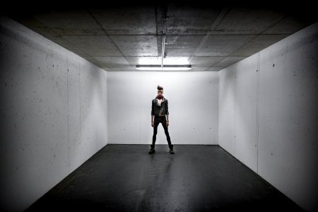 Person Standing Inside White Wall Box Room photo