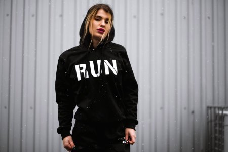 Woman Wearing Black And White Run-printed Pullover Hoodie photo