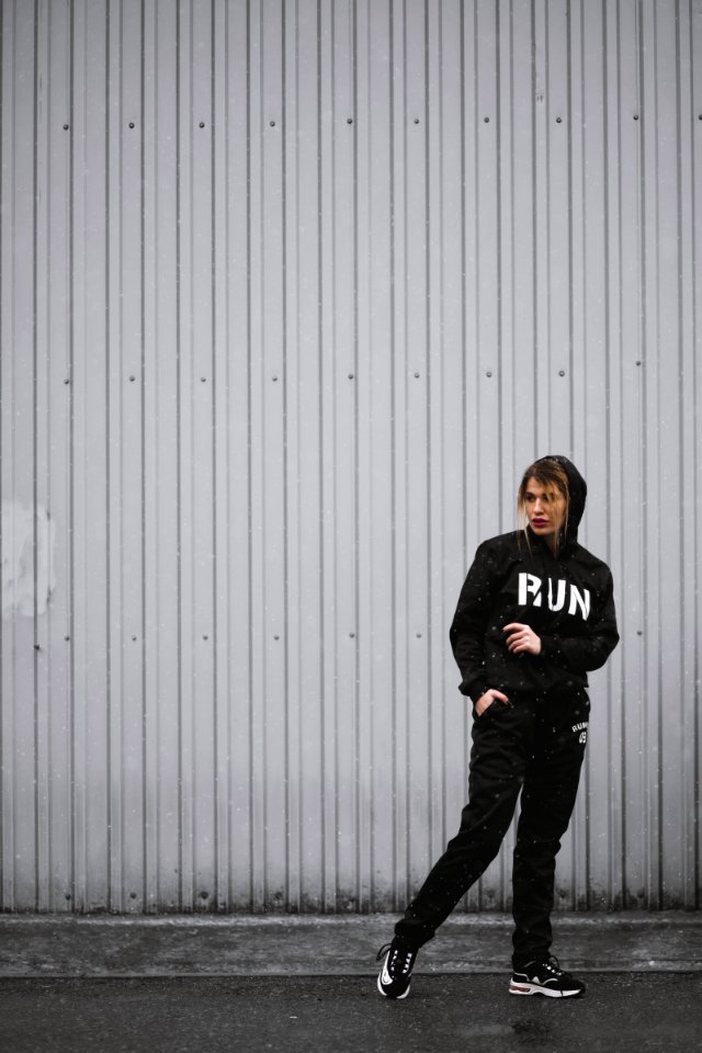 Woman In Black Hoodie Pants And Sneakers