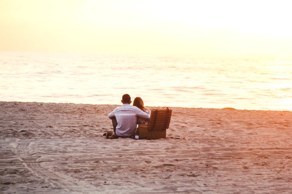 Couple At Beach Near Cooler