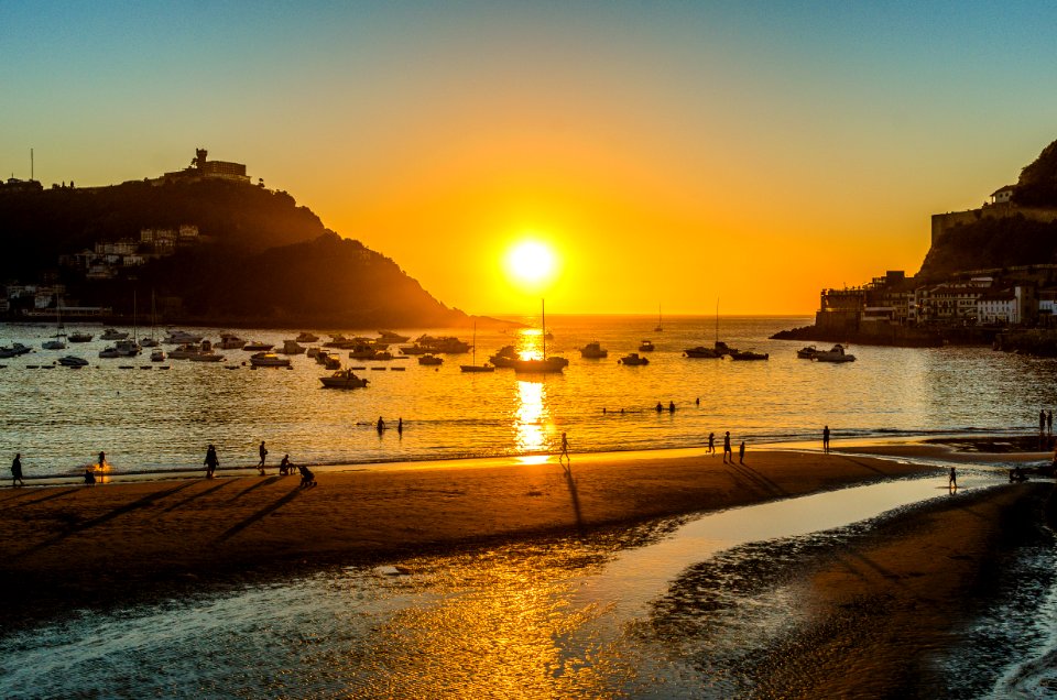 People Walking Beside Seashore photo