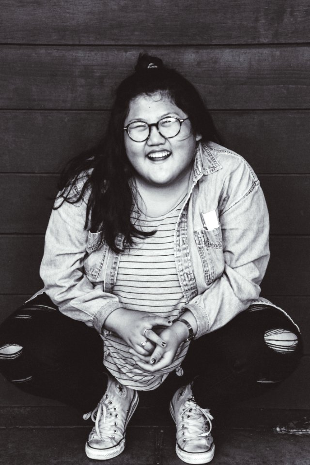 Grayscale Photo Of Woman Squat Sitting