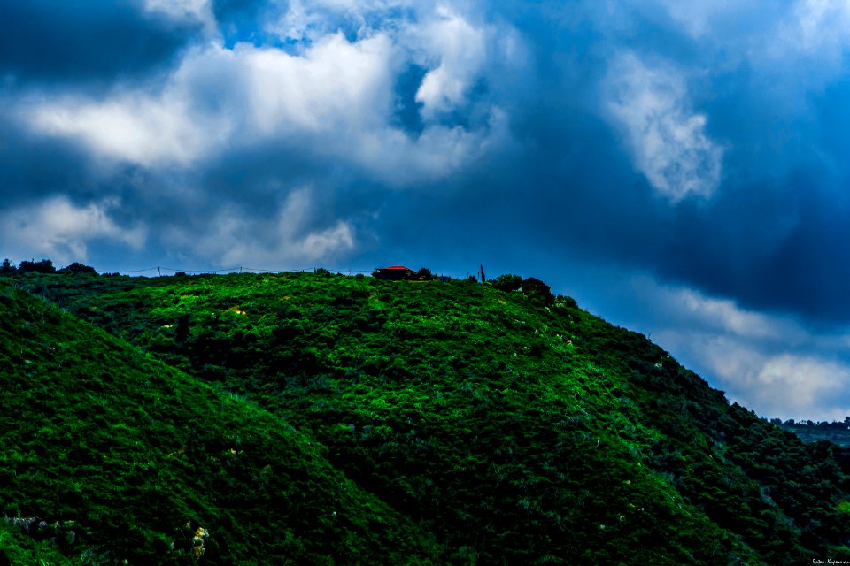 Landscape Photography Of Green Mountain Under Cloudy Sky