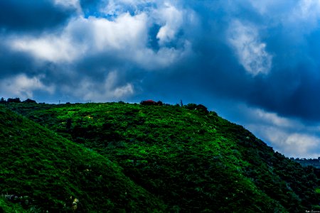 Landscape Photography Of Green Mountain Under Cloudy Sky photo