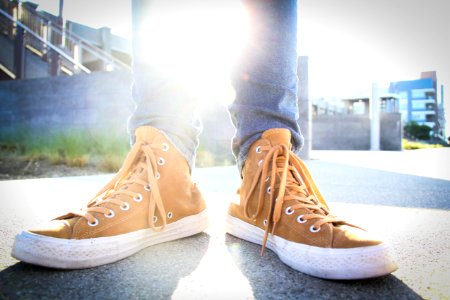 Person Wearing Brown-and-white High-top Sneakers