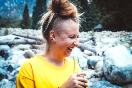 Woman Holding Glass Soda Bottle