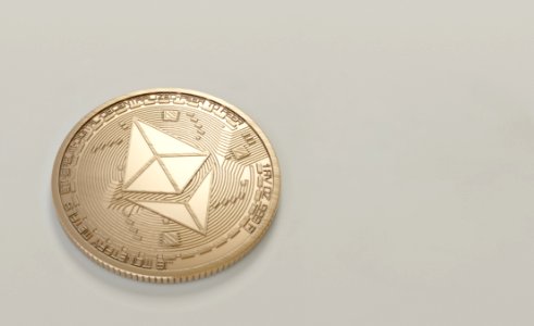 Round Gold-colored Ethereum Coin photo